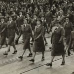 grayscale-photography-of-group-of-women-marching-on-road