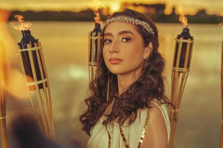 Cleopatra - Woman in White Dress Standing Beside Lighted Torch