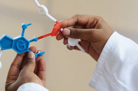 Medicine Technology - Crop chemist holding in hands molecule model