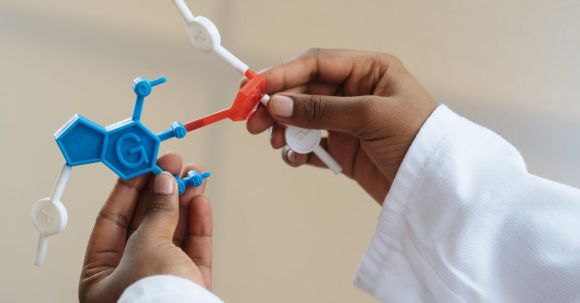 Medicine Technology - Crop chemist holding in hands molecule model